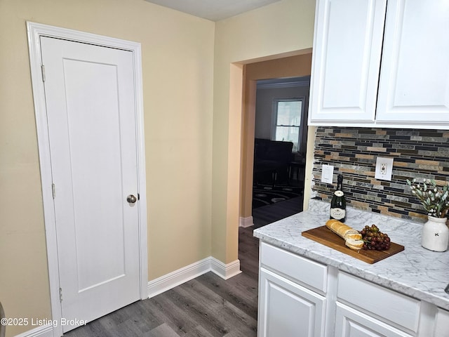 1165 Lincoln Ave, Louisville, KY 40208 - kitchen featuring decorative backsplash, dark wood finished floors, white cabinets, baseboards, and light stone countertops