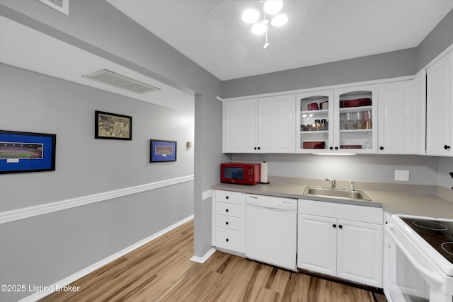 1008 Lake Way Unit D12, Louisville, KY 40222 - kitchen featuring white appliances, a sink, light wood finished floors, white cabinets, and baseboards