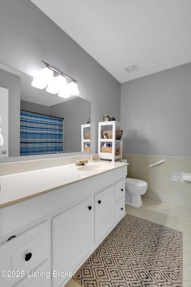 1008 Lake Way Unit D12, Louisville, KY 40222 - bathroom with vanity, tile patterned flooring, toilet, wainscoting, and tile walls