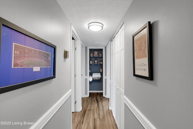 1008 Lake Way Unit D12, Louisville, KY 40222 - hallway featuring a textured ceiling and light wood finished floors