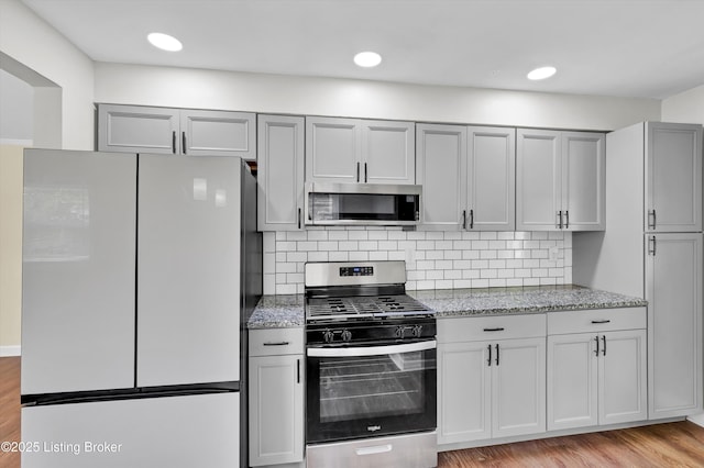4512 Grandview Dr, Louisville, KY 40216 - kitchen with stainless steel appliances, light stone counters, gray cabinets, and recessed lighting