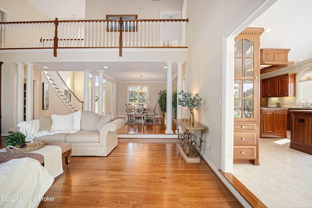 14702 Forest Oaks Dr, Louisville, KY 40245 - living area with light wood-type flooring, a chandelier, ornamental molding, a towering ceiling, and recessed lighting