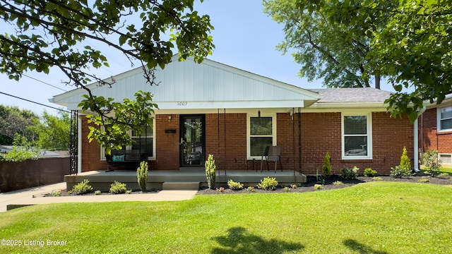1003 Franelm Rd, Louisville, KY 40214 - view of front of property featuring covered porch, a front lawn, and brick siding