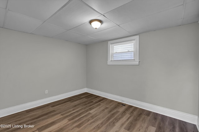 209 W Kenton St, Louisville, KY 40214 - below grade area with baseboards, dark wood-style flooring, and a drop ceiling