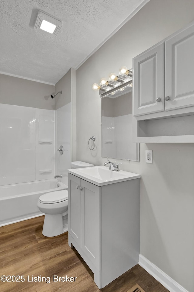 209 W Kenton St, Louisville, KY 40214 - full bath with a textured ceiling, vanity, toilet, tub / shower combination, and wood finished floors