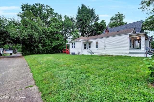 209 W Kenton St, Louisville, KY 40214 - rear view of property with a lawn, a chimney, and a shingled roof