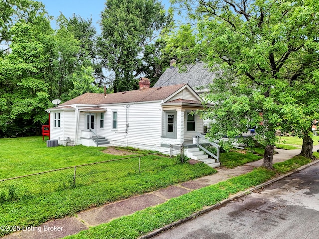 209 W Kenton St, Louisville, KY 40214 - view of front of property with a chimney, central air condition unit, and roof with shingles