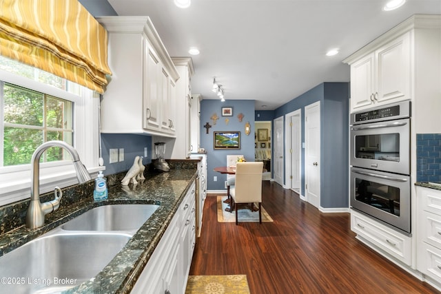 3605 Whitehall Ct, Louisville, KY 40272 - kitchen featuring a sink, double oven, white cabinetry, baseboards, and dark stone counters