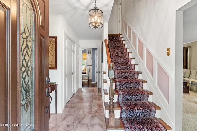 3605 Whitehall Ct, Louisville, KY 40272 - entryway featuring light marble finish flooring, a chandelier, and stairs
