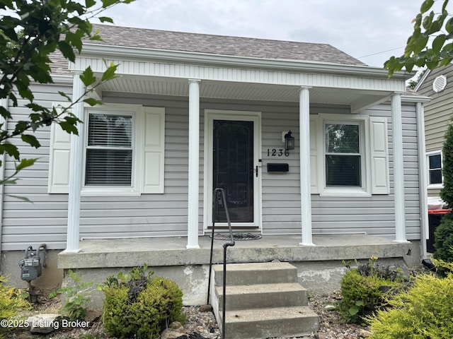 1236 Carrico Ave, Louisville, KY 40215 - property entrance featuring covered porch and roof with shingles