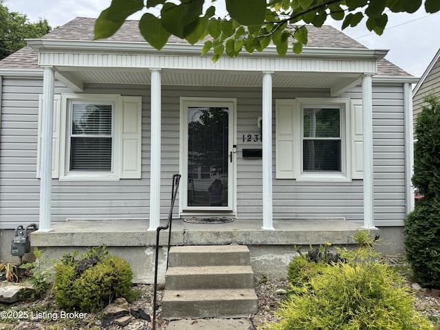 1236 Carrico Ave, Louisville, KY 40215 - doorway to property featuring covered porch and roof with shingles