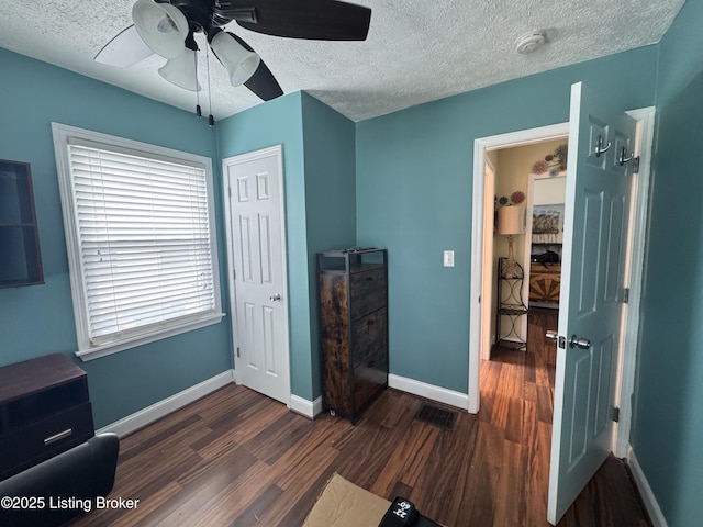 1236 Carrico Ave, Louisville, KY 40215 - bedroom featuring dark wood finished floors, a textured ceiling, baseboards, and ceiling fan