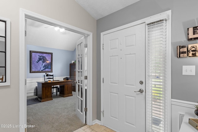 8506 Hunting Stock Pl, Louisville, KY 40291 - entryway featuring carpet flooring, wainscoting, a textured ceiling, french doors, and lofted ceiling