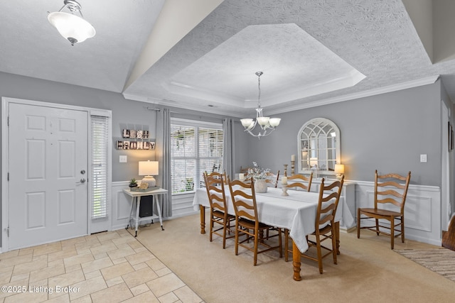 8506 Hunting Stock Pl, Louisville, KY 40291 - dining area featuring a raised ceiling, a chandelier, a textured ceiling, a wainscoted wall, and ornamental molding
