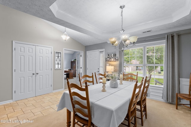 8506 Hunting Stock Pl, Louisville, KY 40291 - dining area featuring a raised ceiling, a textured ceiling, a chandelier, ornamental molding, and light colored carpet