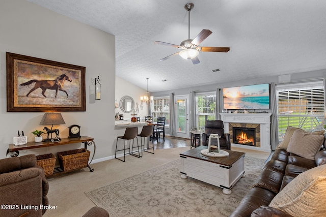 8506 Hunting Stock Pl, Louisville, KY 40291 - living room with a ceiling fan, vaulted ceiling, a textured ceiling, a stone fireplace, and a chandelier