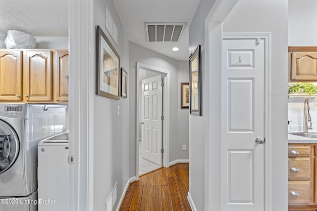 8506 Hunting Stock Pl, Louisville, KY 40291 - laundry area with washing machine and dryer, cabinet space, baseboards, and dark wood-style flooring