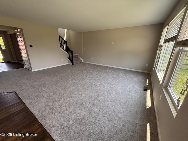 373 University Dr, Walton, KY 41094 - unfurnished living room with stairs, plenty of natural light, and dark colored carpet