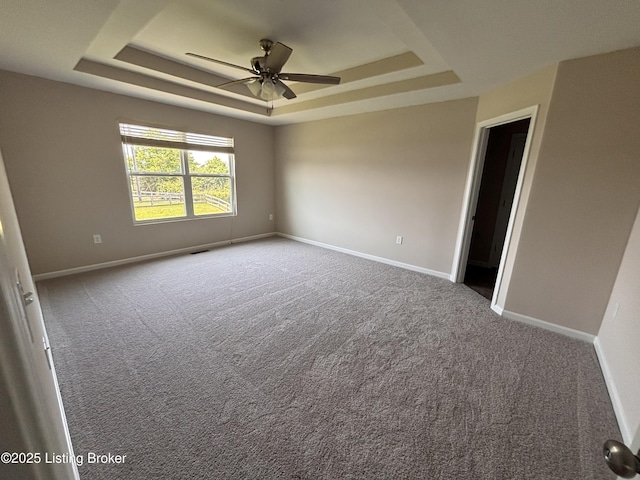 373 University Dr, Walton, KY 41094 - carpeted empty room with a tray ceiling and a ceiling fan