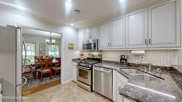 150 E Laurel River Drive Rd, Shepherdsville, KY 40165 - kitchen with appliances with stainless steel finishes, ornamental molding, a sink, a chandelier, and backsplash