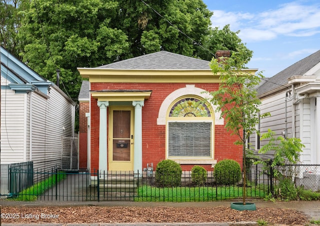 965 S Shelby St, Louisville, KY 40203 - view of front facade with brick siding, roof with shingles, a fenced front yard, and a chimney