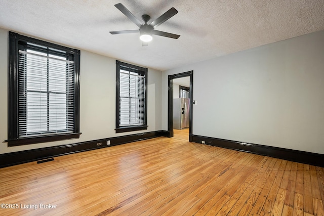 965 S Shelby St, Louisville, KY 40203 - spare room with a textured ceiling, a ceiling fan, light wood-type flooring, and baseboards