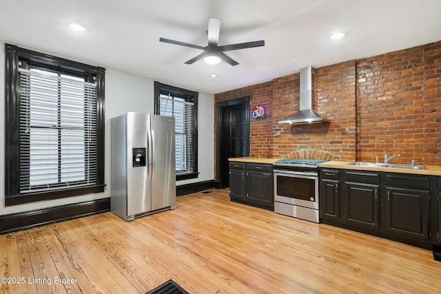 965 S Shelby St, Louisville, KY 40203 - kitchen with appliances with stainless steel finishes, a sink, wall chimney exhaust hood, ceiling fan, and light countertops