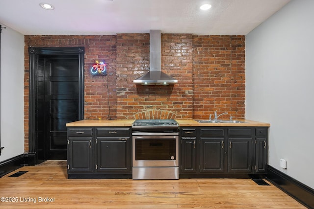 965 S Shelby St, Louisville, KY 40203 - kitchen featuring stainless steel range, wall chimney exhaust hood, a sink, light wood-style floors, and recessed lighting
