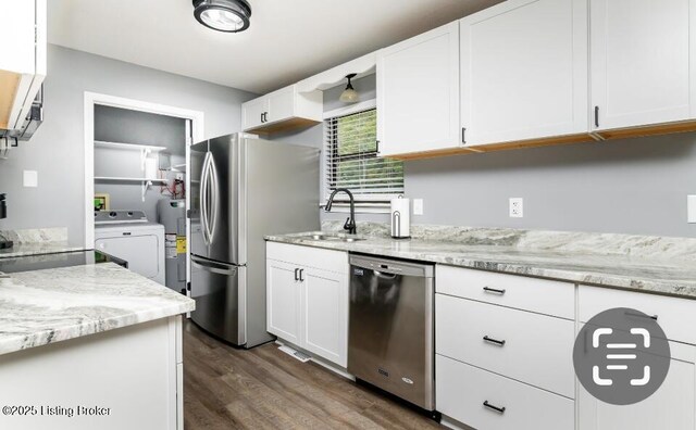 800 Lincoln Dr, Elizabethtown, KY 42701 - kitchen with appliances with stainless steel finishes, washer / dryer, dark wood-style floors, a sink, and white cabinets