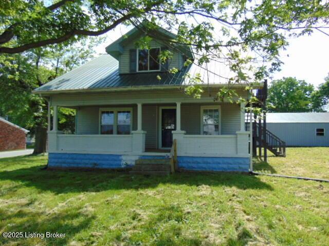 27 Alexander Ave, Bedford, KY 40006 - view of front of home with covered porch, a front yard, and metal roof