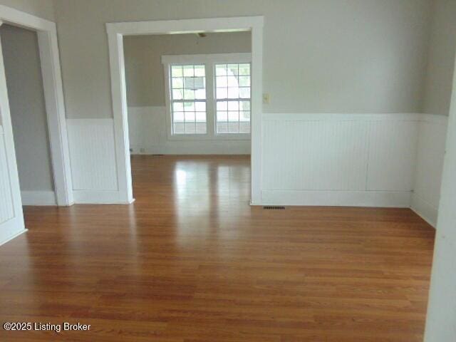 27 Alexander Ave, Bedford, KY 40006 - spare room with a wainscoted wall and wood finished floors