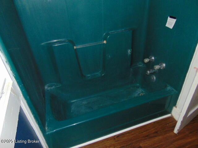 27 Alexander Ave, Bedford, KY 40006 - bathroom view of wood finished floors and washtub / shower combination