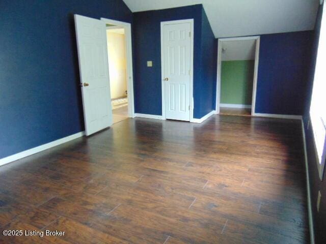 27 Alexander Ave, Bedford, KY 40006 - spare room with vaulted ceiling, wood finished floors, and baseboards
