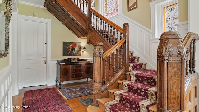 1212 S 2nd St, Louisville, KY 40203 - stairs featuring a decorative wall, a wainscoted wall, wood finished floors, and crown molding