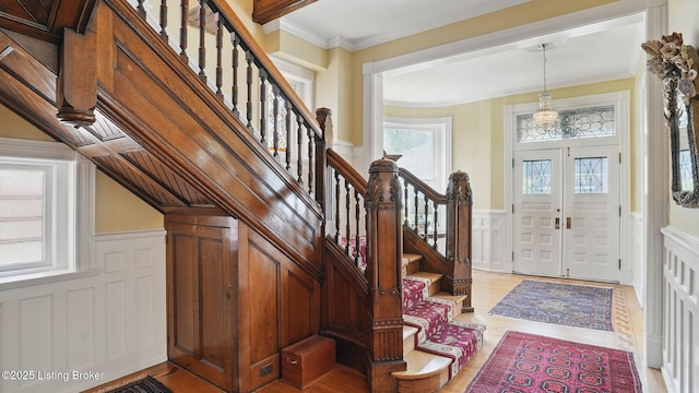 1212 S 2nd St, Louisville, KY 40203 - entryway with a decorative wall, stairway, wainscoting, light wood-style flooring, and ornamental molding