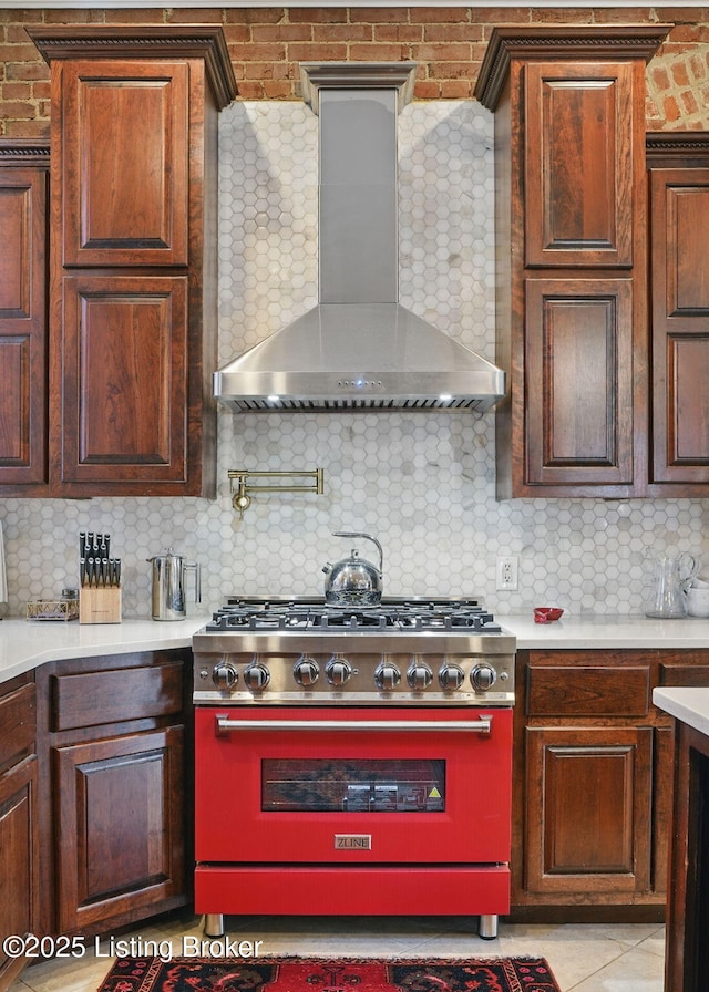 1212 S 2nd St, Louisville, KY 40203 - kitchen with high end stove, wall chimney exhaust hood, backsplash, and light countertops