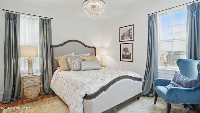 1212 S 2nd St, Louisville, KY 40203 - bedroom featuring a chandelier, crown molding, and light wood-type flooring