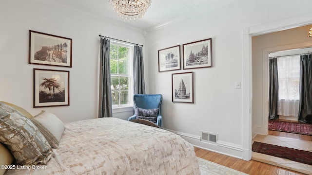 1212 S 2nd St, Louisville, KY 40203 - bedroom with a chandelier, crown molding, and wood finished floors