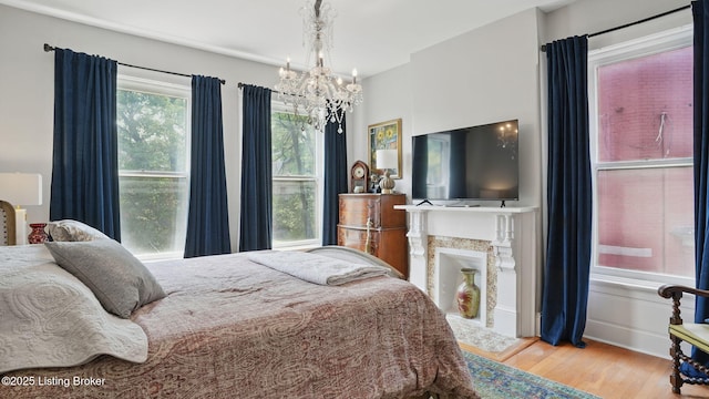 1212 S 2nd St, Louisville, KY 40203 - bedroom featuring a chandelier and wood finished floors
