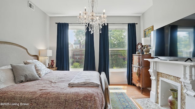 1212 S 2nd St, Louisville, KY 40203 - bedroom with wood finished floors, a chandelier, and a high end fireplace