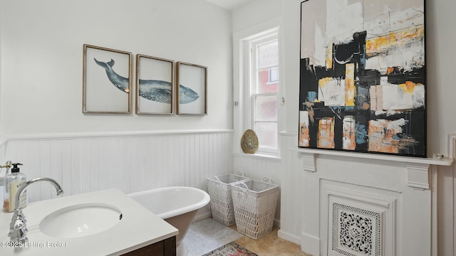 1212 S 2nd St, Louisville, KY 40203 - bathroom featuring a freestanding tub, wainscoting, and vanity