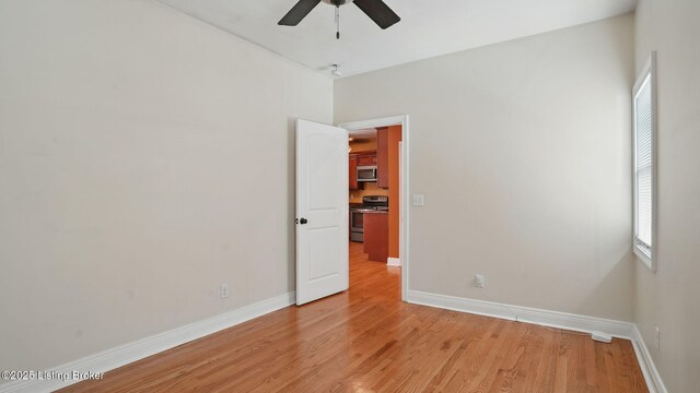 1212 S 2nd St, Louisville, KY 40203 - empty room featuring a ceiling fan, plenty of natural light, and light wood-type flooring