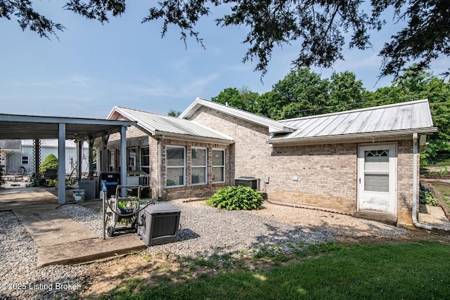 201 Wildflower Ln, Big Springs, KY 40175 - rear view of property featuring brick siding, metal roof, and cooling unit