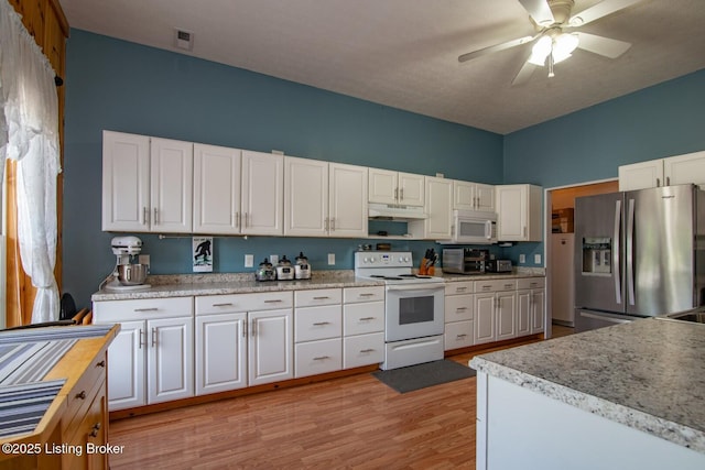 201 Wildflower Ln, Big Springs, KY 40175 - kitchen featuring white appliances, under cabinet range hood, white cabinetry, light countertops, and a towering ceiling