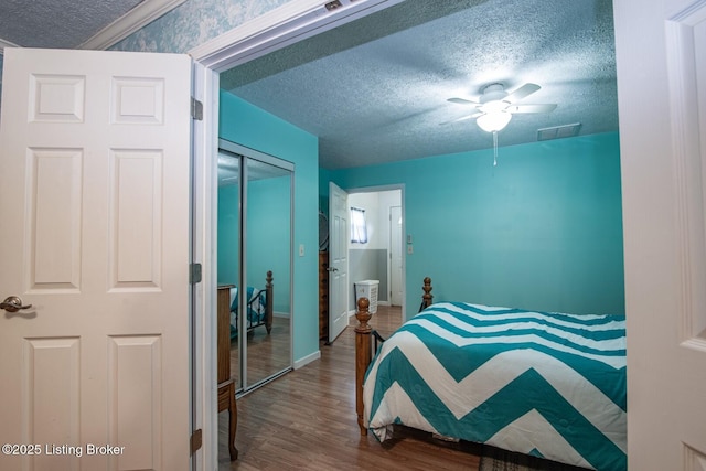 201 Wildflower Ln, Big Springs, KY 40175 - bedroom featuring a textured ceiling, wood finished floors, a closet, baseboards, and ceiling fan