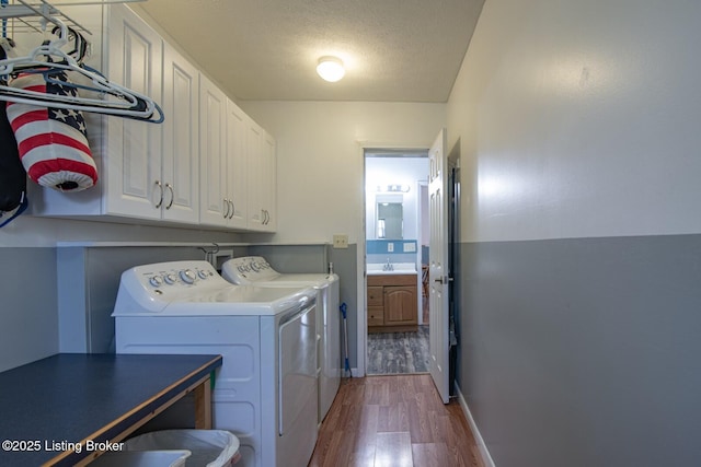 201 Wildflower Ln, Big Springs, KY 40175 - laundry area with cabinet space, independent washer and dryer, dark wood-type flooring, and a textured ceiling