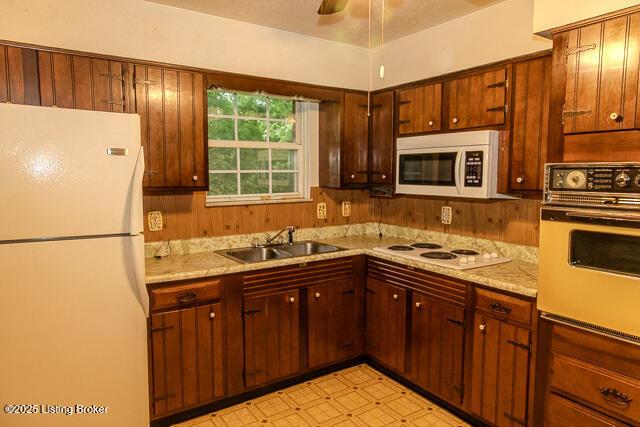 3110 Mount Lebanon Rd, Charlestown, IN 47111 - kitchen featuring white appliances, a sink, light countertops, light flooring, and a ceiling fan