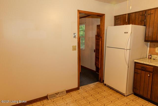 3110 Mount Lebanon Rd, Charlestown, IN 47111 - kitchen featuring freestanding refrigerator, light floors, and baseboards