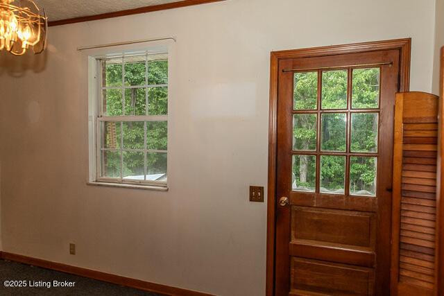 3110 Mount Lebanon Rd, Charlestown, IN 47111 - doorway to outside featuring a chandelier, baseboards, and crown molding
