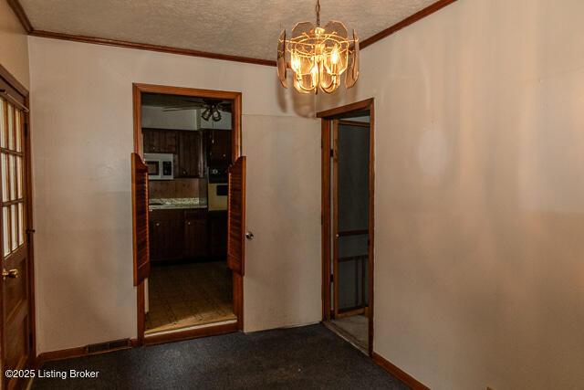 3110 Mount Lebanon Rd, Charlestown, IN 47111 - dining area with a chandelier, ornamental molding, baseboards, a textured ceiling, and carpet
